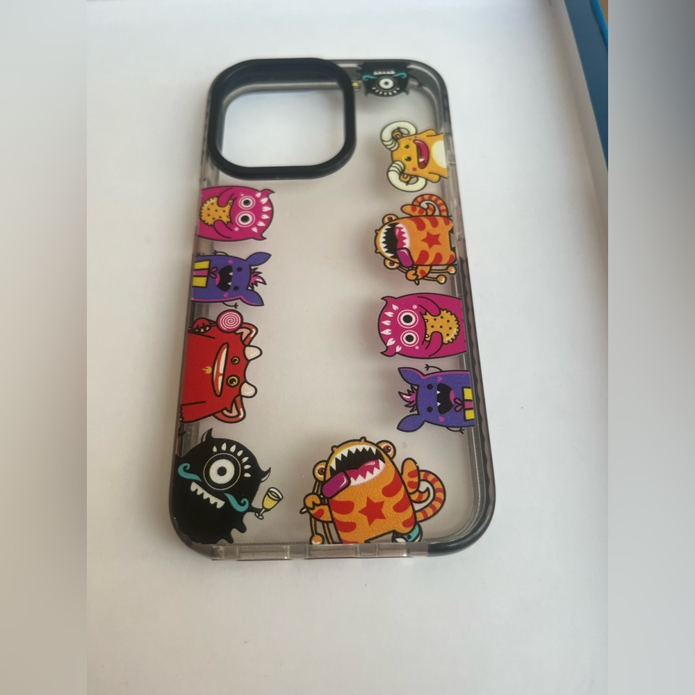 iPhone 13 Pro phone case with cartoon monsters on the sides